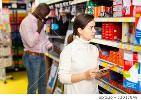 Portrait of woman choosing ball pen at stationery store Portrait of woman choosing ball pen at stationery store 53015948