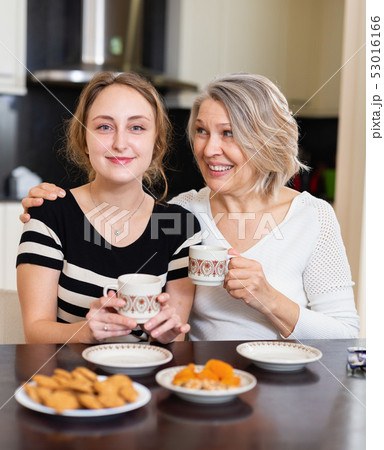Two women talking at table Two women talking at table 53016166