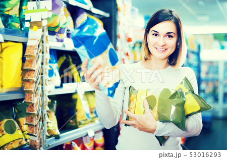 woman choosing delicious snacks in supermarket woman choosing delicious snacks in supermarket 53016293