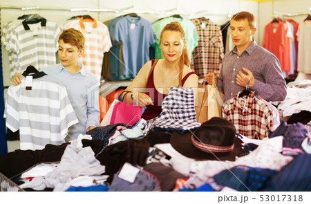 Mother,father and son choosing wear at the clearance sale shop Mother,father and son choosing wear at the clearance sale shop 53017318