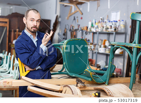 Carpenter repairing antique chair Carpenter repairing antique chair 53017319