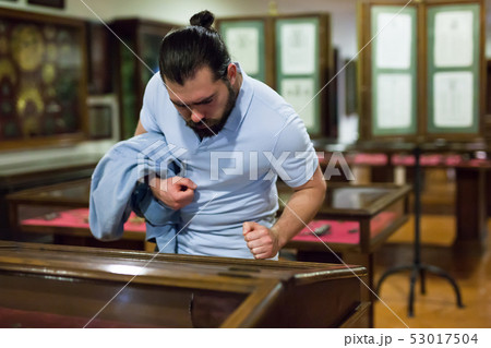Adult man looking at exhibits in glazed stands in historical museum 53017504