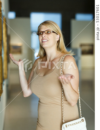 Woman throwing up hands near picture 53017601