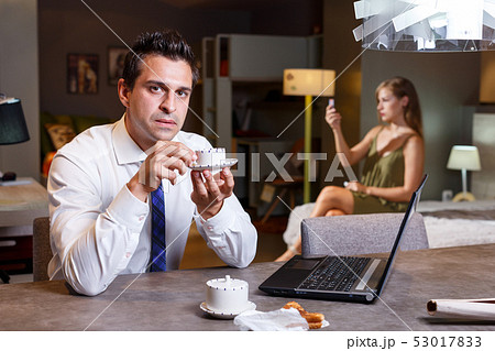 Man drinking coffee and working with laptop 53017833
