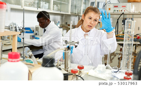 Young female lab technicians working with reagents and test tubes 53017963