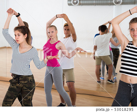 Positive teenagers trying dancing with partner Positive teenagers trying dancing with partner 53018295