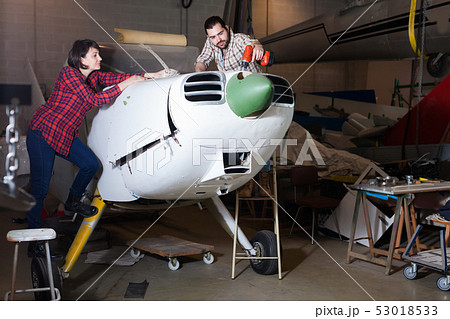 Amateurs restoring sports plane 53018533