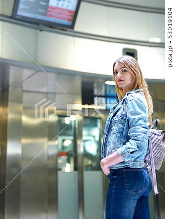 Girl with long hair looks train schedule in the subway Girl with long hair looks train schedule in the subway 53019104