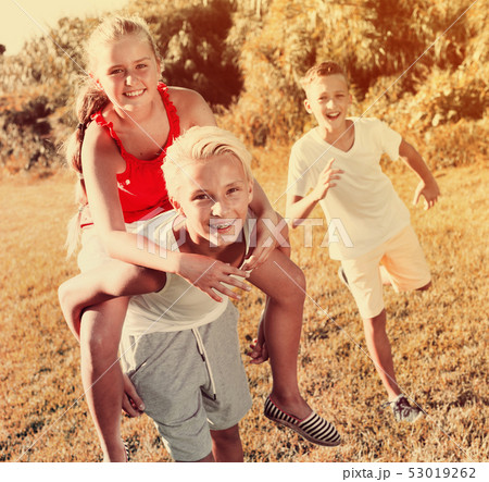 Happy children running together outdoors Happy children running together outdoors 53019262