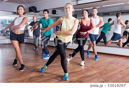 Men and ladies dancing zumba 53019267
