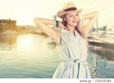 Portrait of smiling woman sitting in the hat 53019289