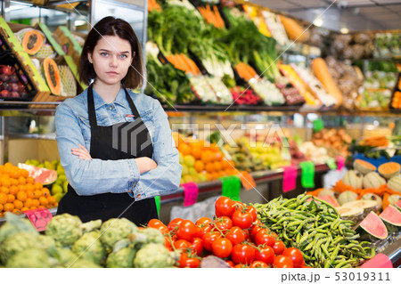 Female seller displaying assortment 53019311