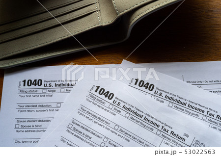 Tax day. The tax form 1040, and empty wallet  is 53022563