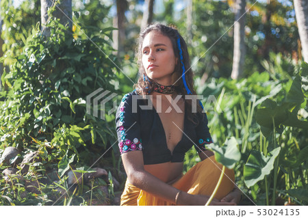 Young beautiful sensual brunette girl on a tropical garden background in ethnic Indian boho style, 53024135