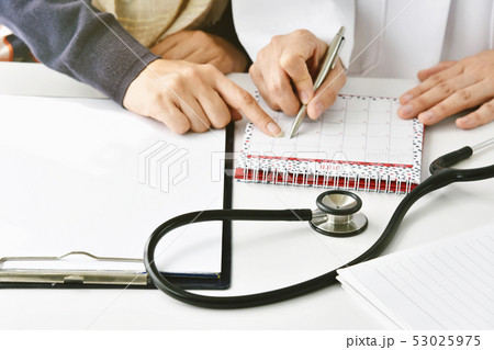 Doctor and patient make an annual health checkup Doctor and patient make an annual health checkup 53025975