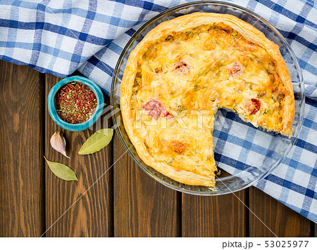Rustic large tart with cloth on a wooden table, view from above, close-up 53025977