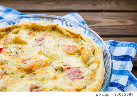 Rustic large tart with cloth on a wooden table, view from above, close-up 53025997