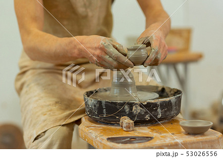 Man with dirty hands wearing protective apron while working Man with dirty hands wearing protective apron while working 53026556