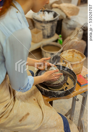 Skinny woman being concentrated on pottery wheel Skinny woman being concentrated on pottery wheel 53026707