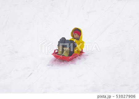 Little Japanese girl is sliding down the snow sled Little Japanese girl is sliding down the snow sled 53027906