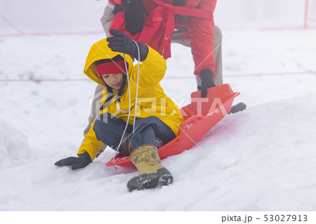 Father is helping her daughter to ride the snow Father is helping her daughter to ride the snow 53027913