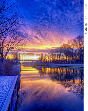 Dramatic and colorful sunrise over a beautiful river landscape Dramatic and colorful sunrise over a beautiful river landscape 53028996