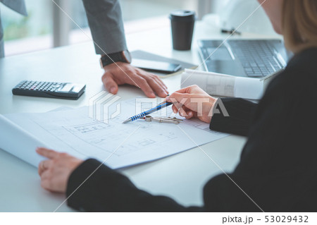 Business man is discussing on sale data in team Business man is discussing on sale data in team 53029432