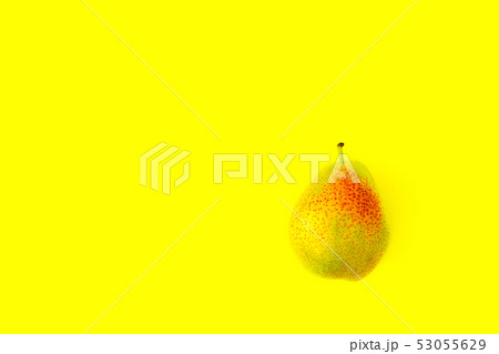 Appetizing ripe pear with red side on a yellow background. Appetizing ripe pear with red side on a yellow background. 53055629