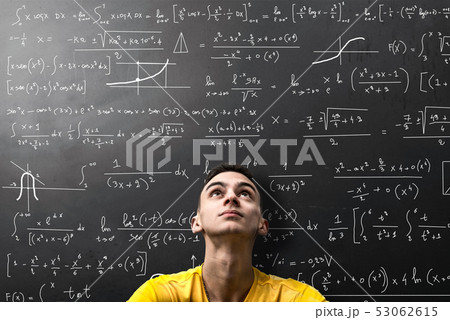 Boy looks apprehensively at a mathematical formula Boy looks apprehensively at a mathematical formula 53062615