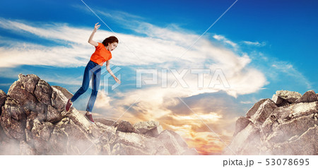 Redhead woman falling down between hills on cliff. Redhead woman falling down between hills on cliff. 53078695