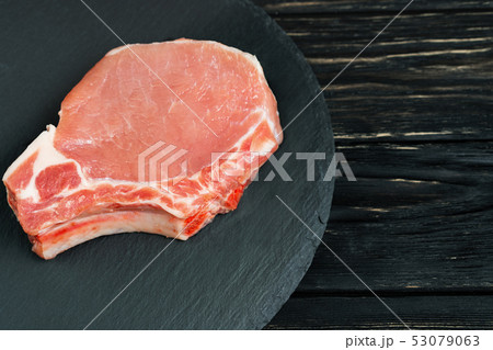 Top view of one pieces raw pork chop steaks on a Top view of one pieces raw pork chop steaks on a 53079063
