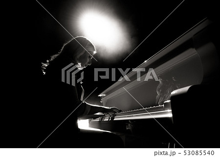 Close up view of a girl plays piano in the concert hall at the scene Close up view of a girl plays piano in the concert hall at the scene 53085540