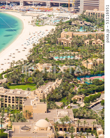 Beach coast with open pool hotels in Dubai. View from the height. Beach coast with open pool hotels in Dubai. View from the height. 53116951