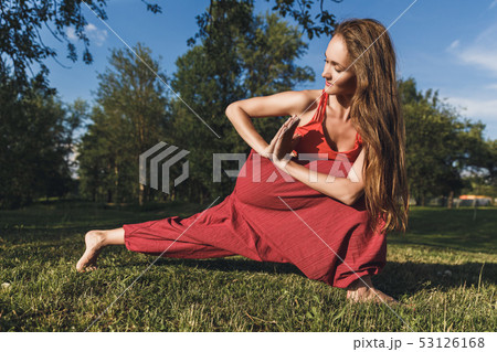 Young woman doing yoga exercises in the summer city park. Health lifestyle concept. 53126168