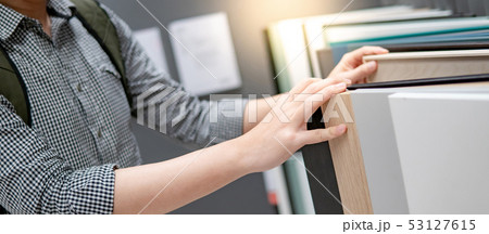 Male hand choosing cabinet or countertop materials 53127615