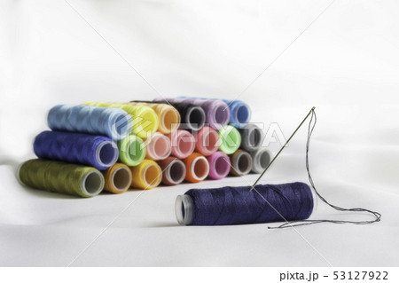Needle,thimble and colorful spools of thread Needle,thimble and colorful spools of thread 53127922