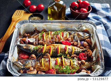 three whole roasted mackerel in a baking pan three whole roasted mackerel in a baking pan 53129877