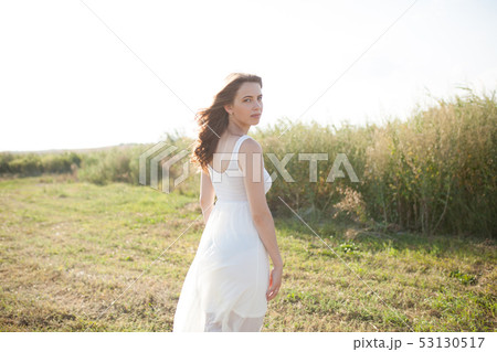 Beautiful caucasian girl walking on the field. 53130517