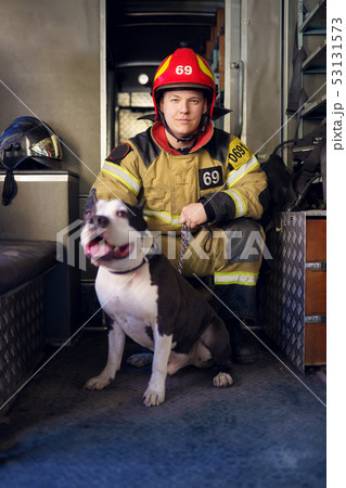 Image of man fireman with lifeguard dog Image of man fireman with lifeguard dog 53131573