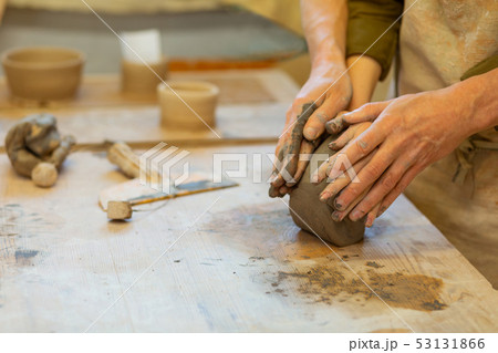 Active lovely couple binding fingers on a piece of clay Active lovely couple binding fingers on a piece of clay 53131866