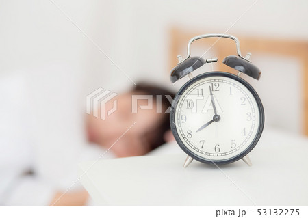 closeup alarm clock and asian woman 53132275