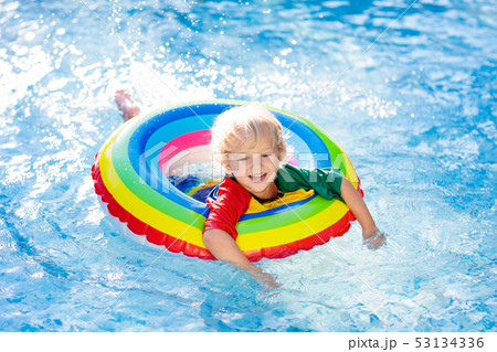 Child in swimming pool on toy ring. Kids swim. Child in swimming pool on toy ring. Kids swim. 53134336