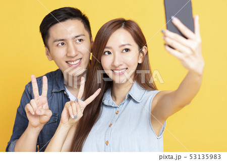 young woman making selfie with boyfriend 53135983