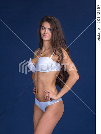 Slim woman on blue background Slim woman on blue background 53142267