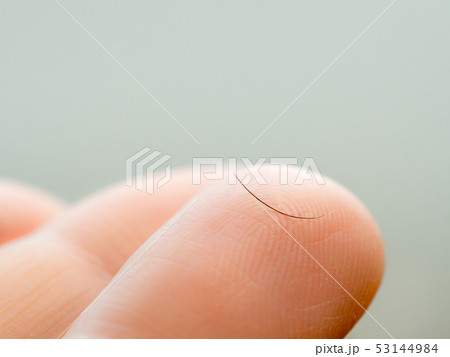 One dropped eyelash on finger, macro shoot 53144984