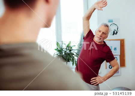 Pleasant aged man having a sports workout Pleasant aged man having a sports workout 53145139