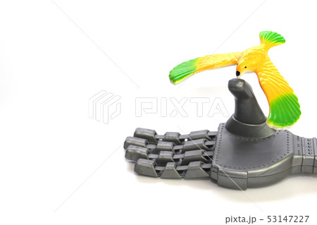 A little bird is sitting on the finger of a robot. A little bird is sitting on the finger of a robot. 53147227