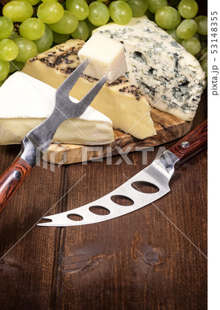 Cheese, grapes of the white wine, knife and fork Cheese, grapes of the white wine, knife and fork 53148355