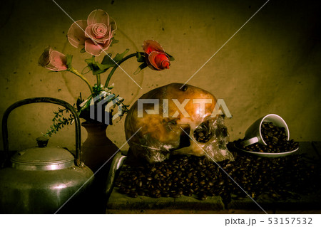 Human skull placed on coffee beans on old wood, Human skull placed on coffee beans on old wood, 53157532