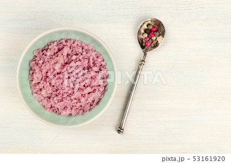 Gourmet Spices. A bowl of pink Himalayan sea salt with a pepper mix, shot from the top on a white 53161920